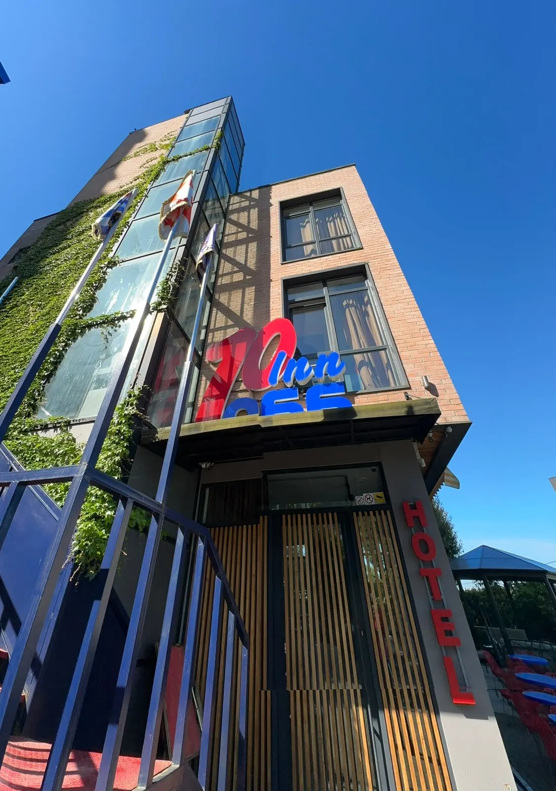 The hotel tower and 10 Inn sign against a deep blue sky