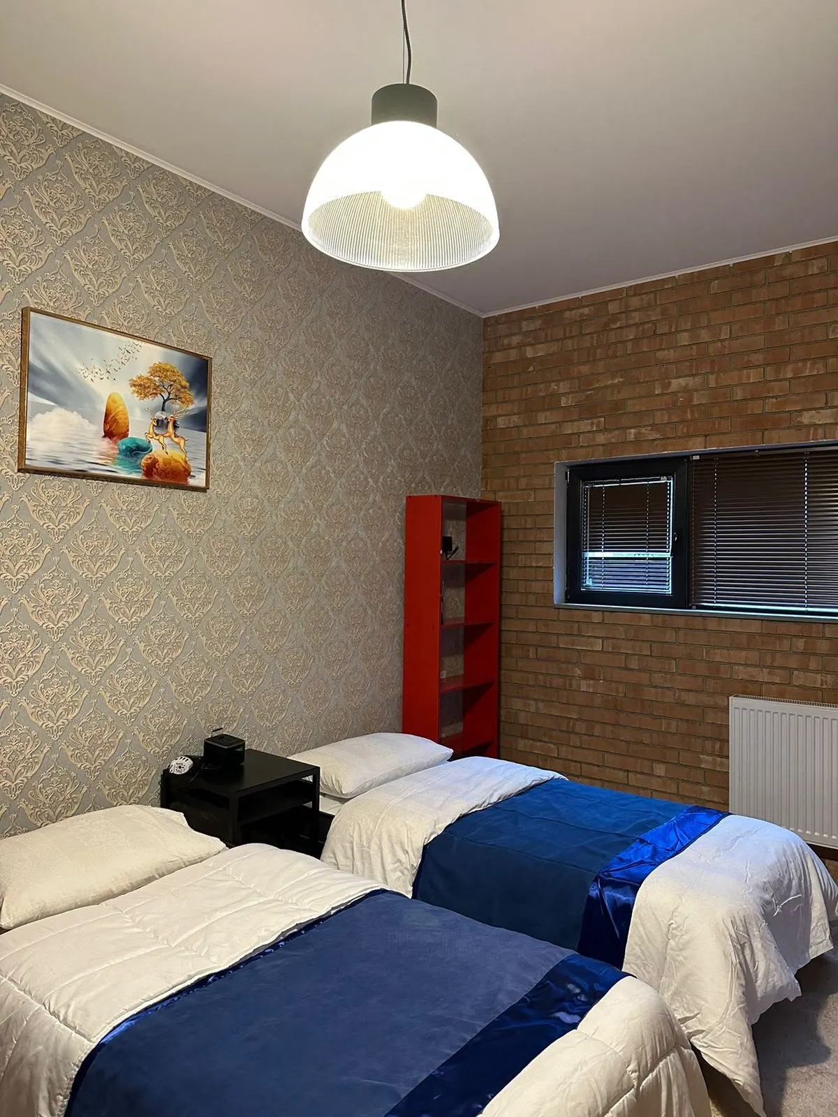 Twin room with two beds and navy throws