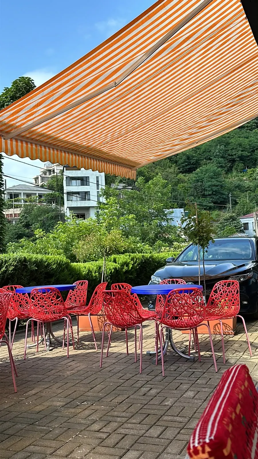 Red chairs on the sunny front terrace